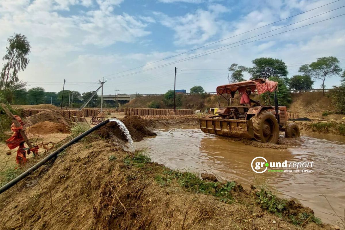Farmer Irrigating Field