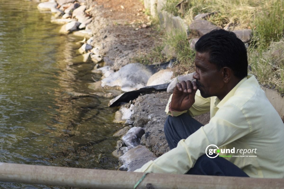 Fisherman looking at pond