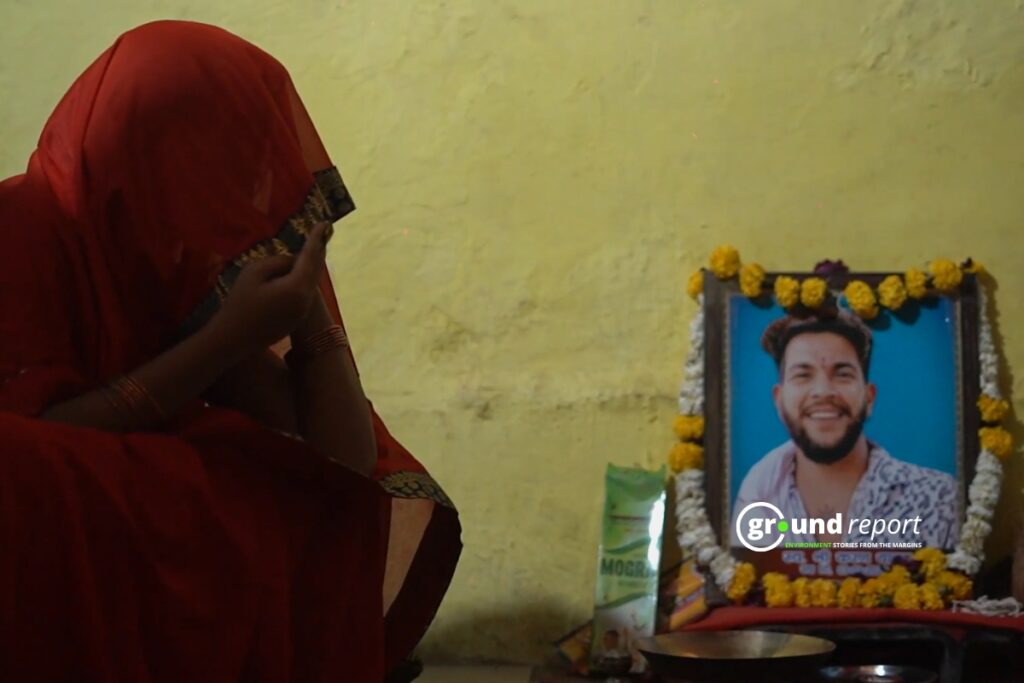 Karan's wife Kavita Yadav looking at his photo