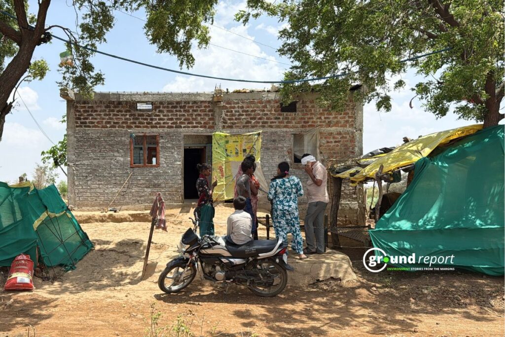 Residents gather outside their homes in Patharia village, Rajgarh district, Madhya Pradesh