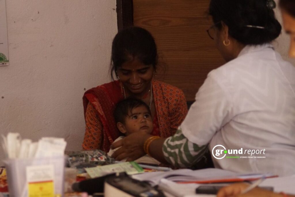 Auxiliary Nurse Midwife Sushila Vijay Vargi vaccinates a child