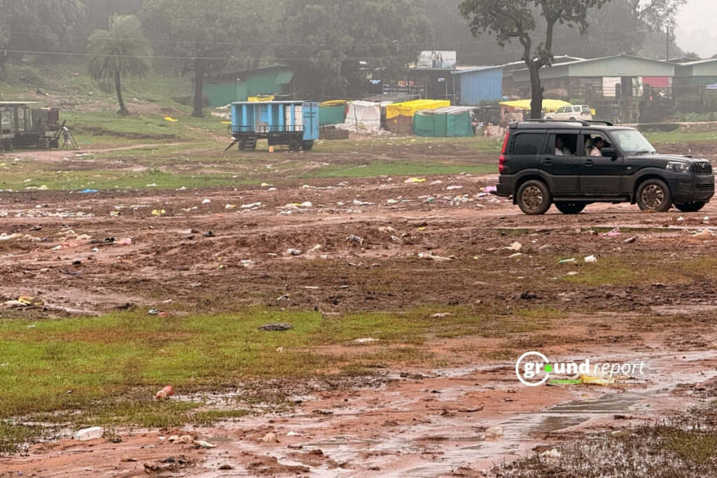 A Vehicle Drives Past Litter-strewn Mud Flats Where the Mela Once Stood