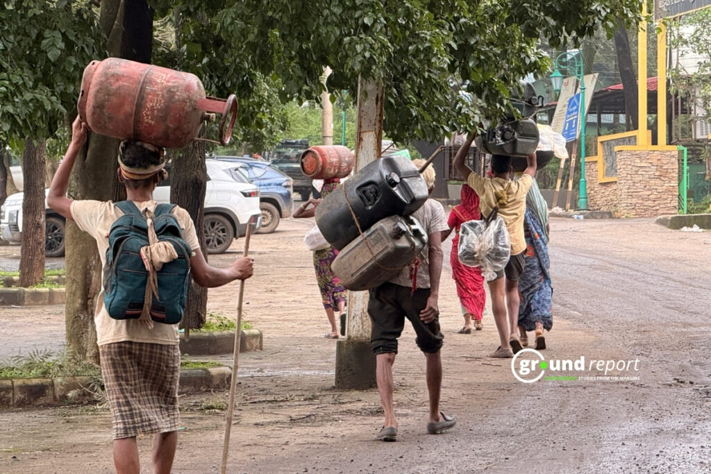 Pilgrims Carry Gas Cylinders and Containers on Their Heads as They Leave Pachmarhi