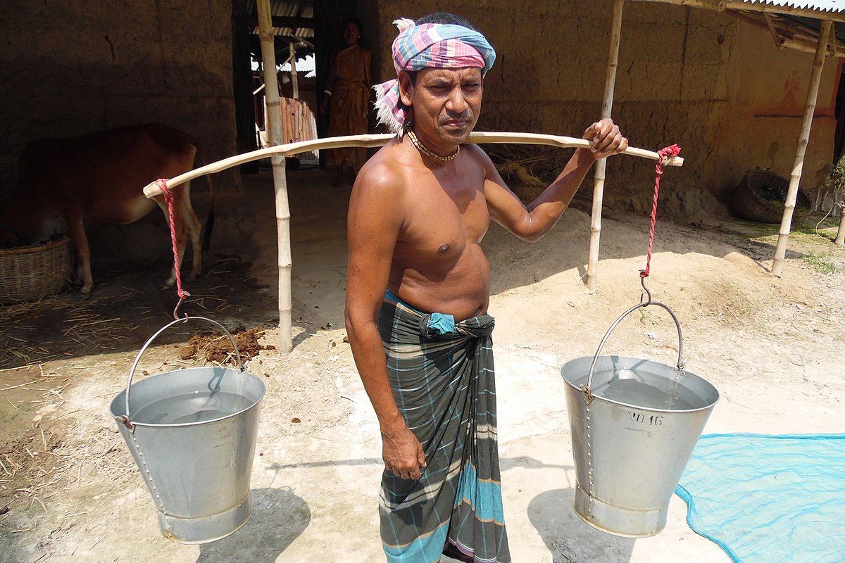 A man collect drinking water from a long distanced area.