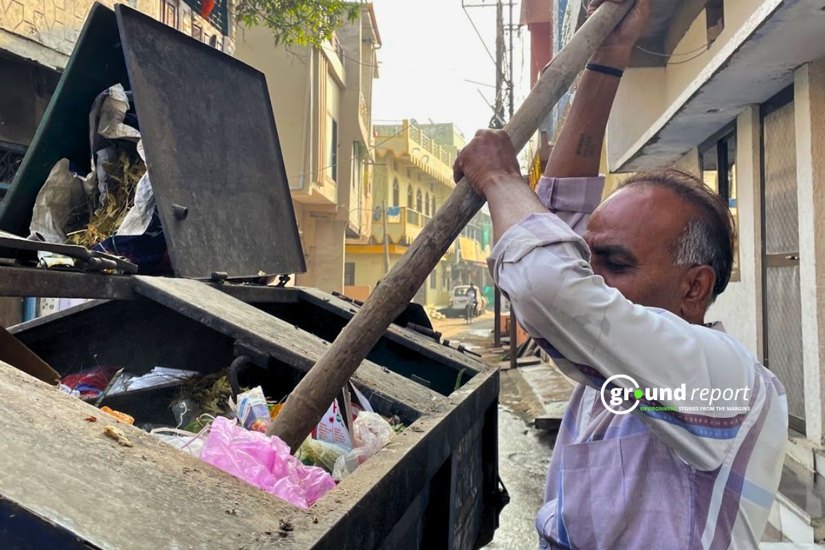 Prajapati makes space for more garbage in the garbage vehicle