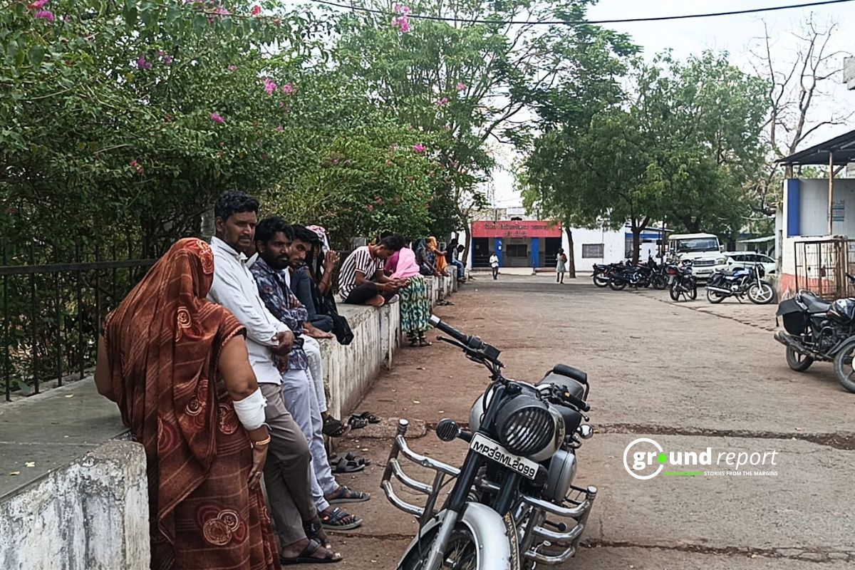Mod Singh in white shirt standing outside hospital under decorative trees shade