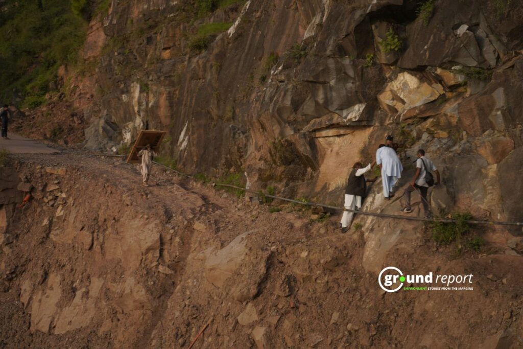 People struggle to get their belongings out of their damaged homes.
