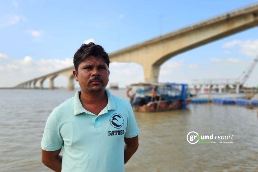 Dolphin Mitra Santosh Mahaldar stands by the Vikramshila Setu—a parallel bridge 38 km away from the fallen bridge—behind him.