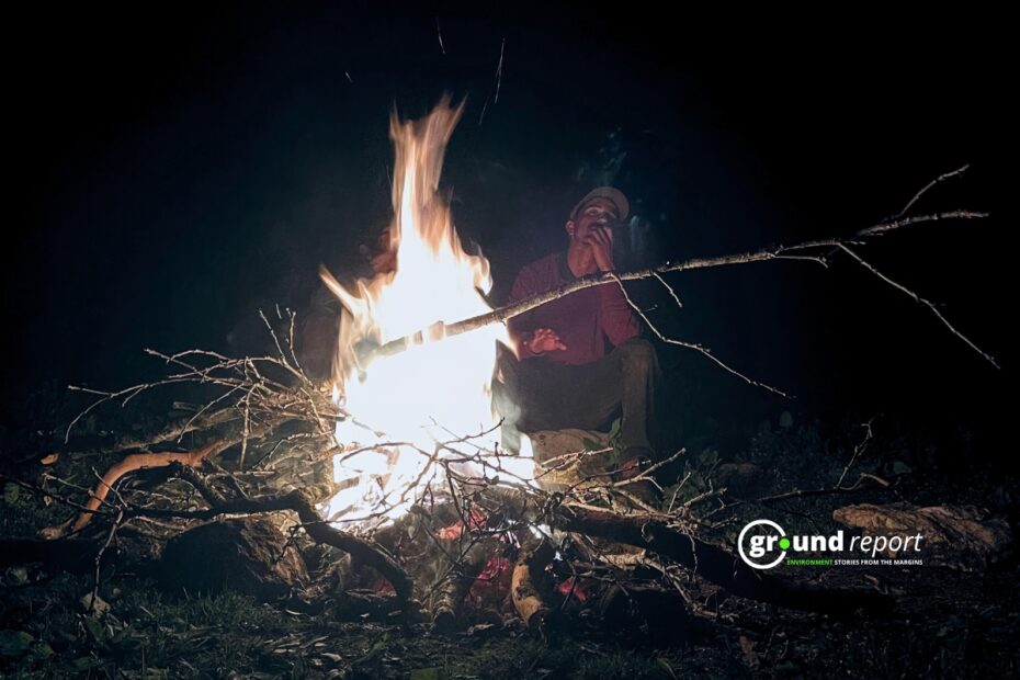 A man sitting in front of camp fire to take resort from coldwave