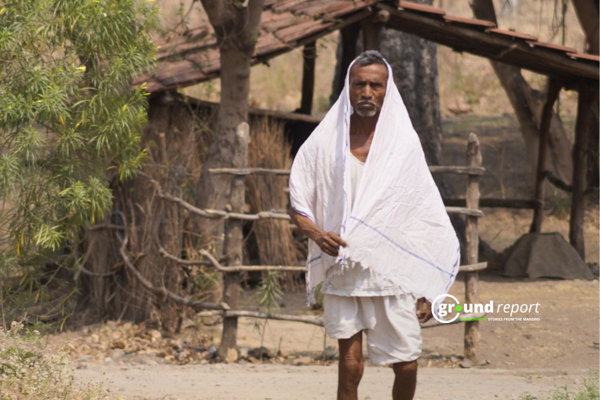 An elderly man walks in the afternoon heat in a village in Madhya Pradesh as temperatures rise early in March. Photo credit: Ground Report