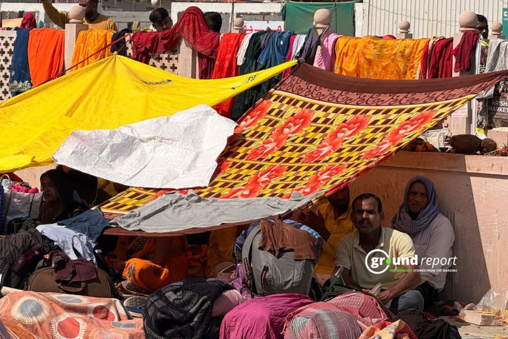 Travellers rest under makeshift cloth shade to escape the afternoon heat in Madhya Pradesh.