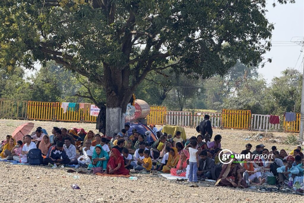 People sit under a tree for shade as temperatures rise during the day in central India.