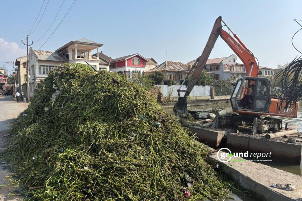 excavator actively removes accumulated waste from the lake