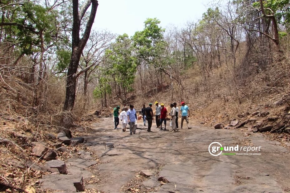 Volunteers passing through the stream that recharges the source of the Betwa River.