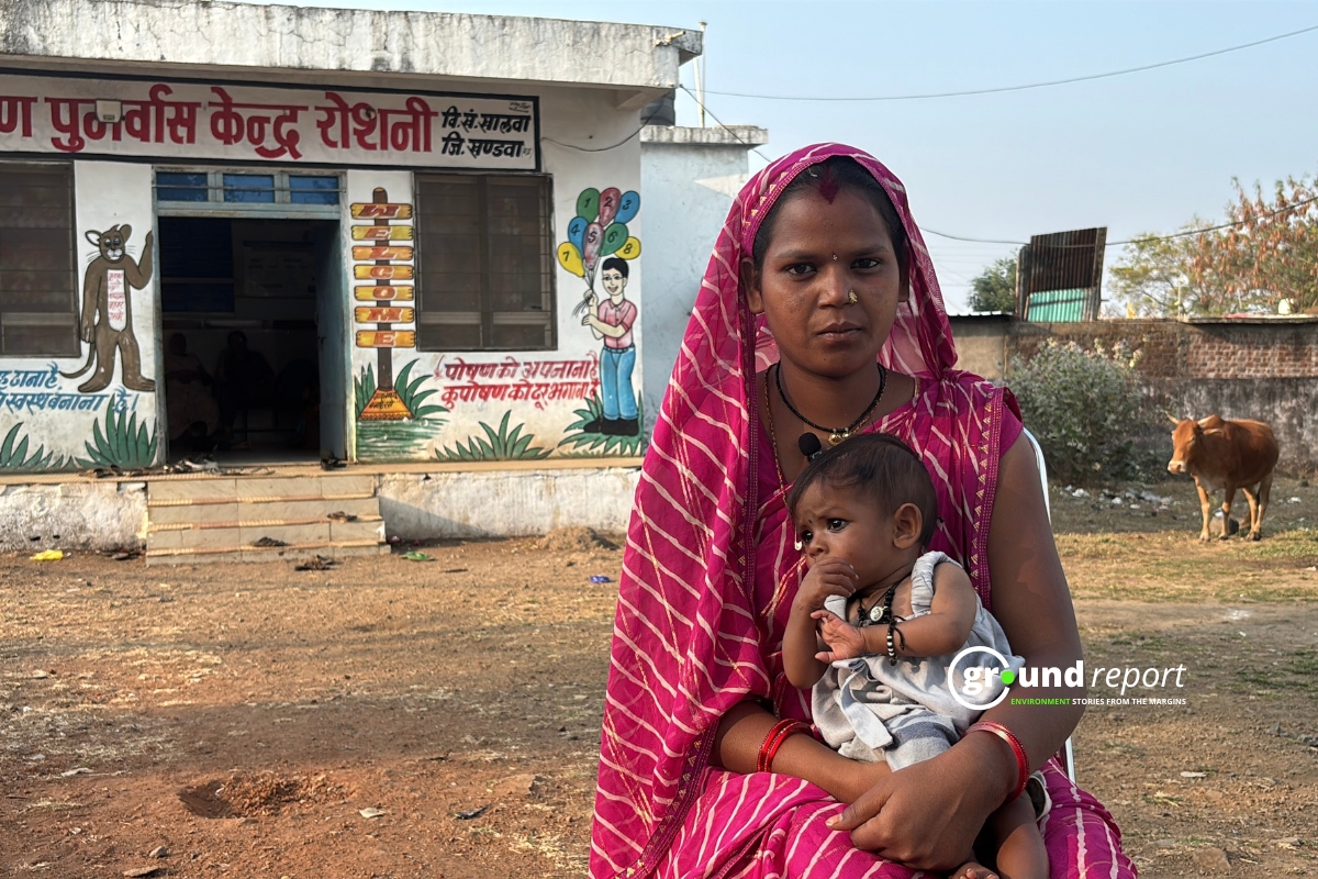 A mother holds her baby outside a nutrition rehabilitation center in rural India.